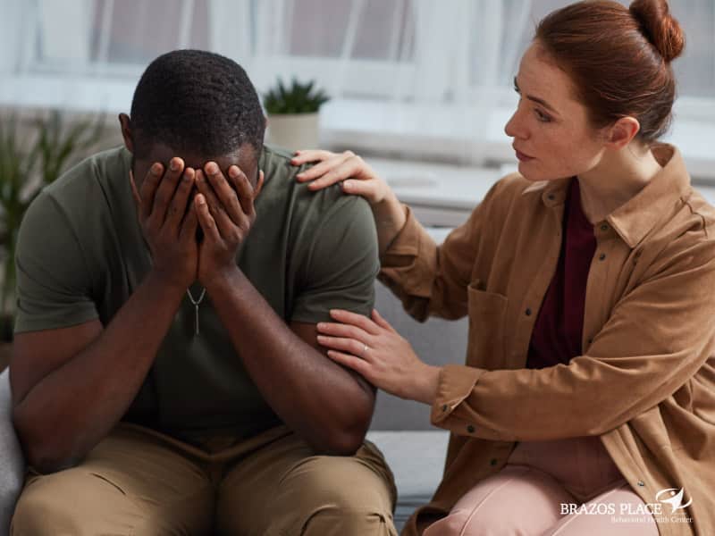 Woman comforting a crying man
